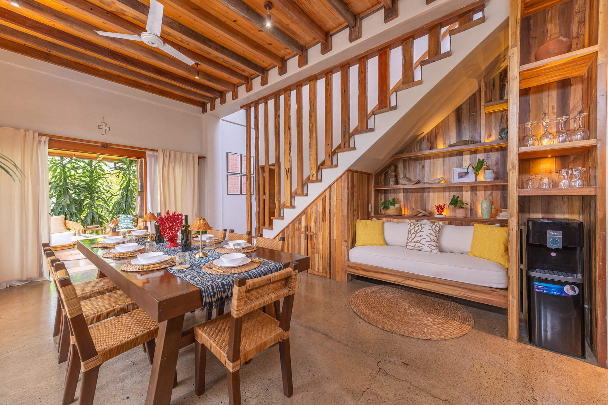 The Residence — dining and kitchen with reclaimed-wood stairs